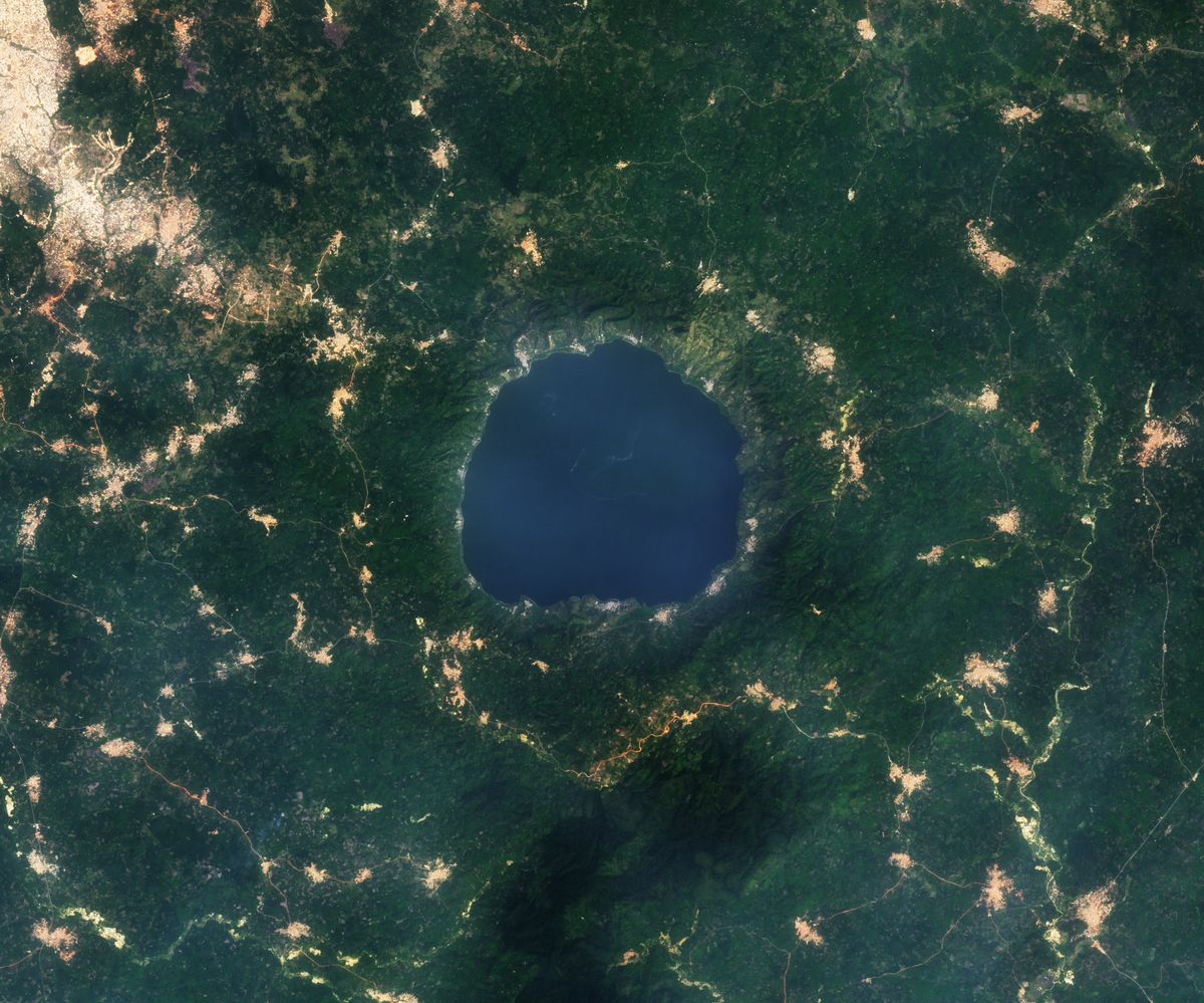 Satellite view of Lake Bosumtwi, a near-circular crater lake ringed by forest in the Ashanti Region of Ghana
